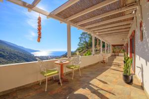 a balcony with a table and chairs and a view at Ölüdeniz Manzara Non Alcoholic Family Hotel in Oludeniz