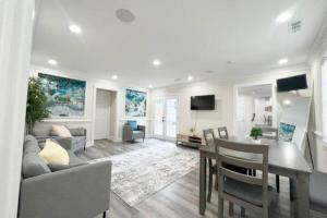 a living room with a couch and a table at The Beach Pad - Your Private Oasis with a Cool Beachy Vibe in Manassas Park