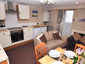 a kitchen and living room with a couch and a table at 2 Bed in Cosheston FB060 in Cosheston