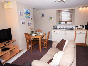 a living room with a white couch and a table at 2 Bed in Cosheston FB060 in Cosheston