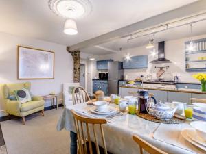 a kitchen and living room with a table and chairs at 3 Bed in Great Hucklow 77715 in Hucklow