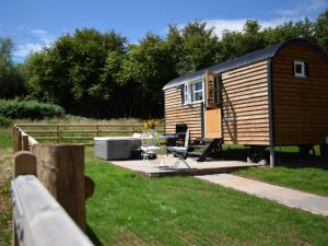 a tiny house sitting in a yard next to a fence at 1 Bed in Hereford 78641 in Callow