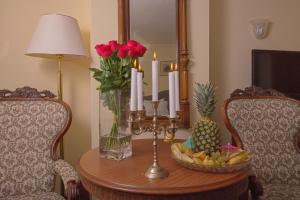 a table with candles and a bowl of fruit on it at Hotel Tyl in Prague
