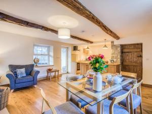 a kitchen and living room with a glass table and chairs at 3 Bed in Hartington 77739 in Hartington