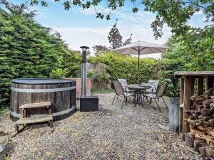 a patio with a table and an umbrella at 2 Bed in Oswestry 76537 in Gobowen