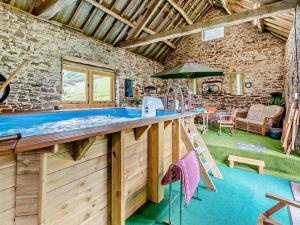 an outdoor kitchen with a bar and a table and chairs at 1 Bed in Abergavenny BN113 in Pont Newydd