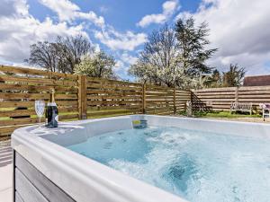 a hot tub with a bottle of wine and a glass at 2 Bed in Bidford-on-Avon 82334 in Barton