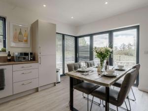a kitchen and dining room with a table and chairs at 2 Bed in Usk 82391 in Trostrey
