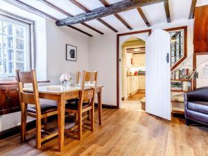 a dining room with a wooden table and chairs at 2 Bed in Winster 81043 in Winster