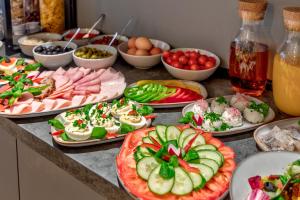 a table with pizzas and other food on it at Cotton House in Łódź