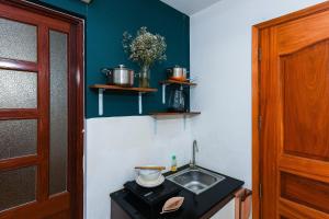 a small kitchen with a sink and a counter at Home De Art -303 in Ho Chi Minh City +60 photos