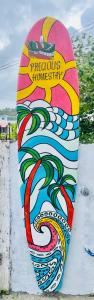 a surfboard painted on the side of a wall at Precious Homestay-Family Room in Burgos