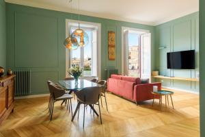 a living room with a red couch and a table at Palermo al Massimo in Palermo