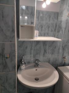 a bathroom with a sink and a mirror at Apartman Luka in Kupres +12 photos