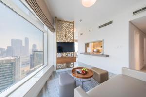 a living room with white walls and a large window at Boutique Living - Burj Views - Renovated in Dubai