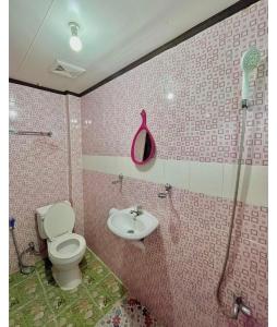 a bathroom with a toilet and a sink at Precious Homestay-Family Room in Burgos