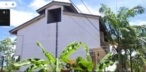 a white building with a window on the side of it at Kian's Place in Matara