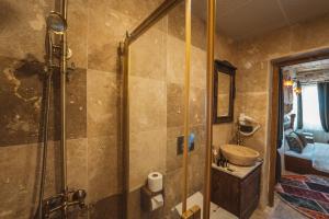 a bathroom with a shower and a sink at Alin Stone House in Uchisar