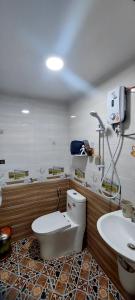 a bathroom with a toilet and a sink at SKY HOMESTAY in Buon Ma Thuot