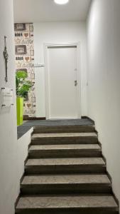 a stairway leading to a white door with a white door at Appartamenti ClesioResidenceBuonconsiglio in Trento