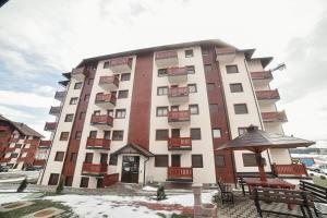 a large white building with balconies on it at Apartman Ivkovic Zlatibor in Zlatibor