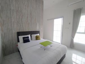 Una cama o camas en una habitación de Urbanview Hotel Nimara Ngawi by RedDoorz