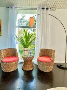 a room with three chairs and a table with a lamp at MyHOME At Shangrila Height in Kota Kinabalu