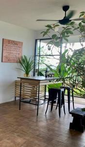a dining room with a table and some plants at MyHOME At Shangrila Height in Kota Kinabalu
