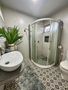 a bathroom with a shower and a sink and a toilet at MyHOME At Shangrila Height in Kota Kinabalu