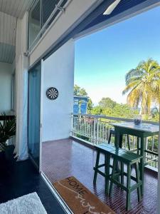 a balcony with a table and a view of the ocean at MyHOME At Shangrila Height in Kota Kinabalu