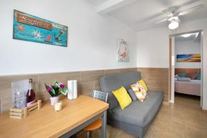 a living room with a couch and a table at Apartamento La Morena 3b in El Pris +15 photos