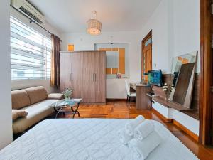 a bedroom with a bed and a living room at Home De Art -303 in Ho Chi Minh City
