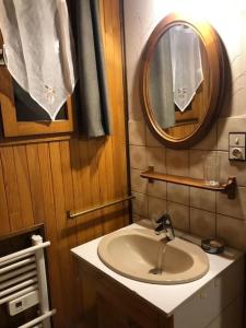 a bathroom with a sink and a mirror at Chalet de montagne Pierre et Gaby non-fumeur hôte non professionnel in Saint-Jean-d'Aulps