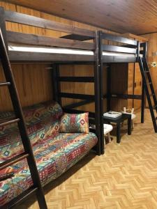 a living room with two bunk beds and a couch at Chalet de montagne Pierre et Gaby non-fumeur hôte non professionnel in Saint-Jean-dʼAulps