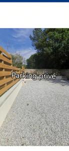 a rendering of a driveway with a wooden fence at La chaumière in Longues-sur-Mer