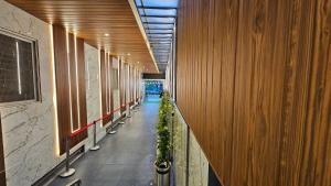 a hallway with a row of plants in a building at Emerald Urban Comforts in Mysore