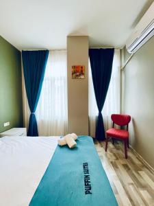 イスタンブールにあるPuffin Boutique - Istanbulのベッドルーム1室(ベッド1台、赤い椅子付)