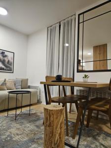ein Wohnzimmer mit einem Tisch und einem Sofa in der Unterkunft Mek lux Bjelasnica in Bjelašnica