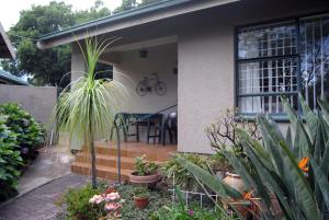 a house with a porch with plants in front of it at Stop-a-While in Krugersdorp