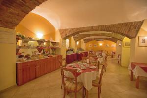 a restaurant with tables and chairs and a counter at Hotel Tyl in Prague