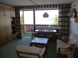 a living room filled with furniture and a large window at Ferienwohnpark Oberallgäu in Missen-Wilhams