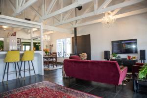 a living room with a couch and a bar at Mettahouse in Cape Town