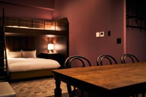 a bedroom with a bunk bed and a table and chairs at Rakuten STAY Kokura Station in Kitakyushu