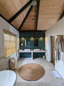 un baño grande con 2 lavabos y una alfombra grande en Kalinaw Resort en General Luna
