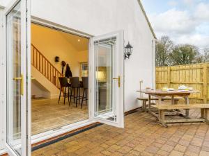 a sliding glass door leading to a patio with a table at 1 Bed in Bishop Auckland 86812 in Byers Green