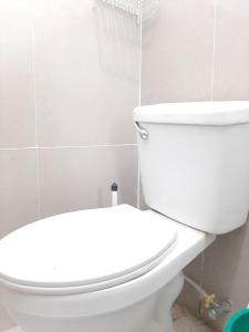 a bathroom with a white toilet in a room at Subangan bayud3, Burgos central location in Burgos