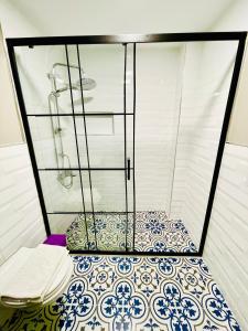 a bathroom with a shower and a tiled floor at Puffin Boutique - Istanbul in Istanbul