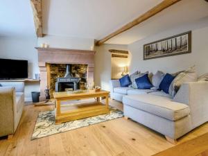 a living room with a couch and a fireplace at 2 Bed in Ullswater 87349 in Penrith