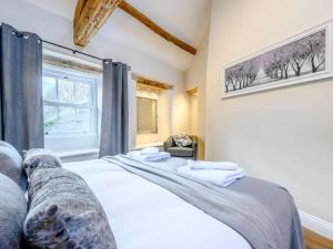 a bedroom with a bed and a window at 2 Bed in Ullswater 87349 in Penrith