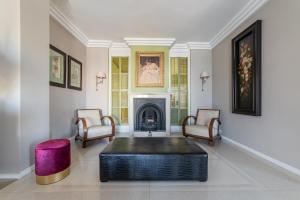 a living room with a fireplace and a table and chairs at HOME TAWN Luxury Apartment Bari in Bari +22 photos